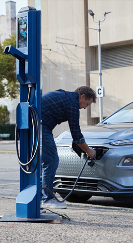 Electric Vehicles - Man Charging Electric Car
